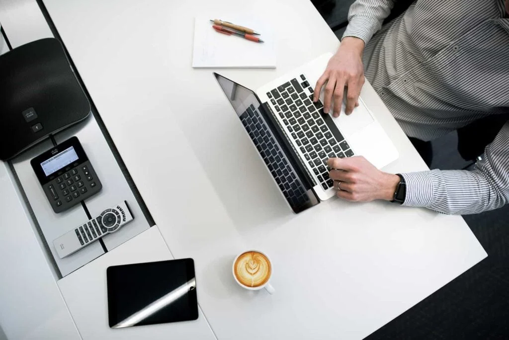 man using laptop with cup of tea Optimize Content for SEO