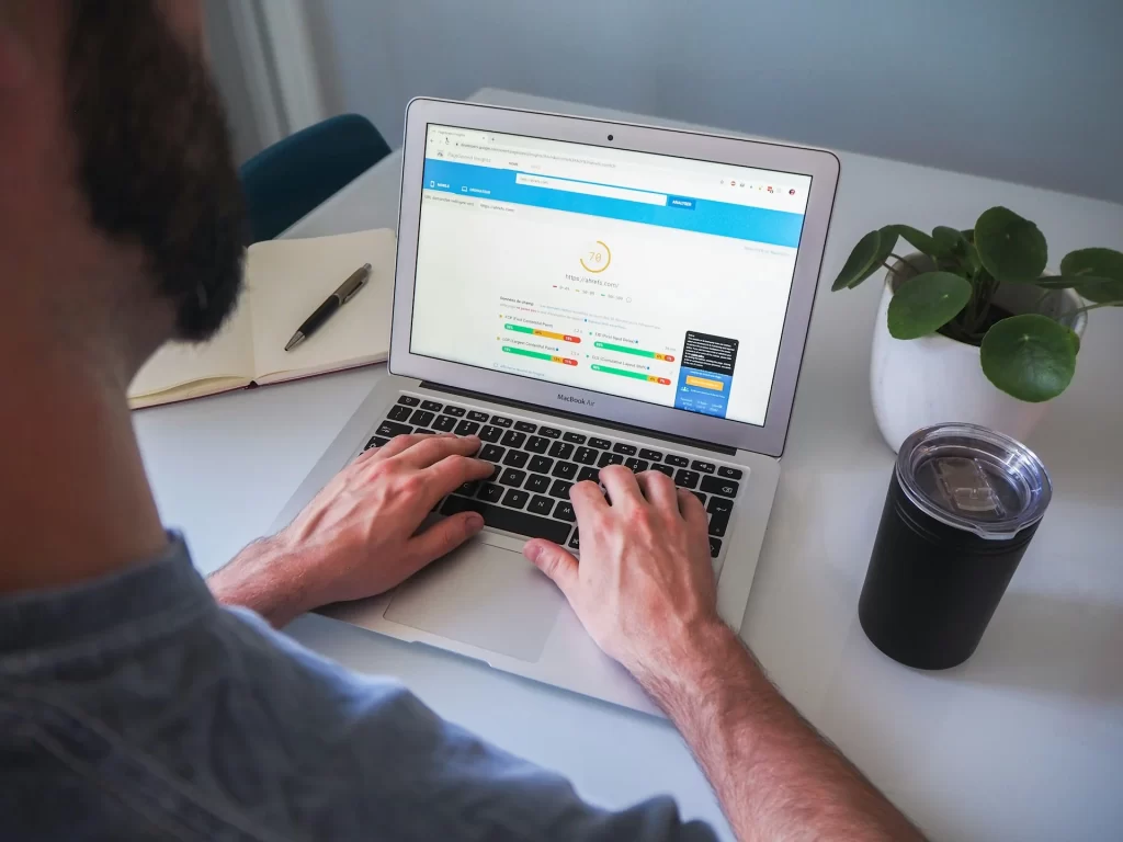 man using laptop Optimize Content for SEO